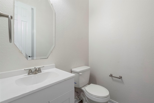 10101 Waterview Pkwy, Rowlett, TX 75089 - half bath with toilet, vanity, and a textured wall