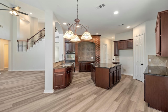 10101 Waterview Pkwy, Rowlett, TX 75089 - kitchen featuring stainless steel oven, light wood finished floors, tasteful backsplash, a ceiling fan, and recessed lighting