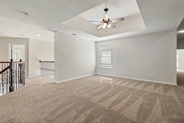 10101 Waterview Pkwy, Rowlett, TX 75089 - spare room featuring ceiling fan, carpet flooring, baseboards, a raised ceiling, and a smoke detector