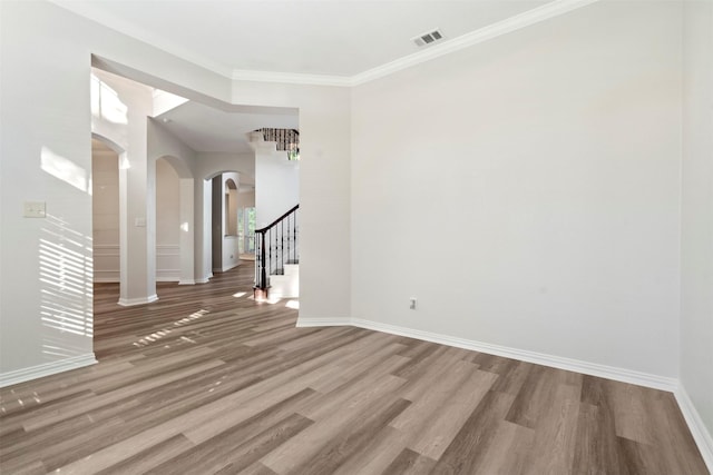 10101 Waterview Pkwy, Rowlett, TX 75089 - empty room with arched walkways, wood finished floors, stairway, baseboards, and ornamental molding