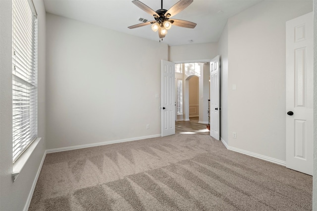 10101 Waterview Pkwy, Rowlett, TX 75089 - unfurnished bedroom with arched walkways, carpet, baseboards, and ceiling fan