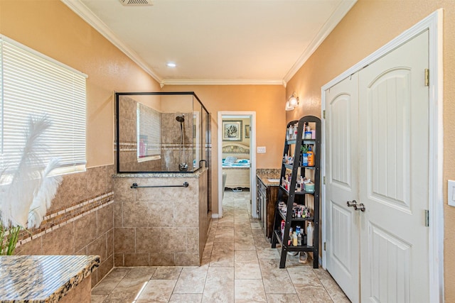 bathroom featuring a shower stall, crown molding, tile walls, and vanity