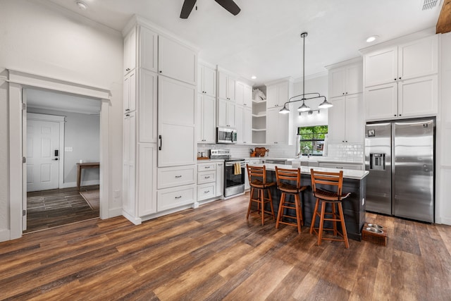 608 N Belknap, Stephenville, TX 76401 - kitchen with stainless steel appliances, open shelves, white cabinetry, recessed lighting, and ornamental molding