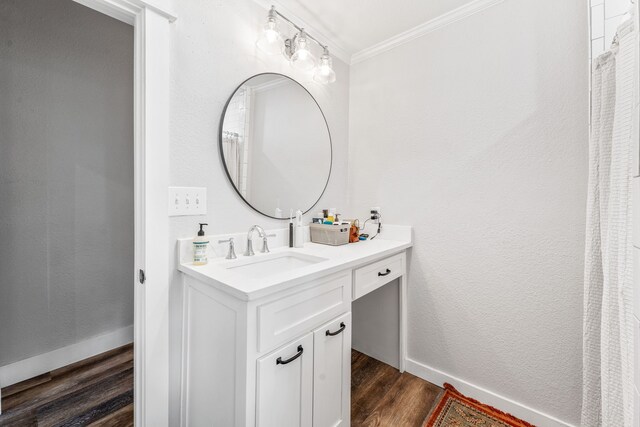 608 N Belknap, Stephenville, TX 76401 - bathroom with crown molding, wood finished floors, vanity, and baseboards