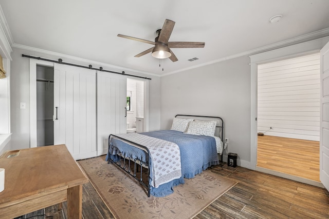 608 N Belknap, Stephenville, TX 76401 - bedroom with crown molding, wood finished floors, a barn door, baseboards, and ceiling fan