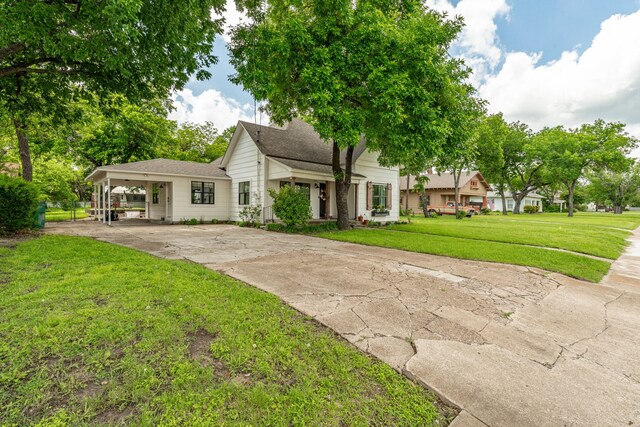 608 N Belknap, Stephenville, TX 76401 - view of front of house with driveway, a front lawn, a carport, and a shingled roof