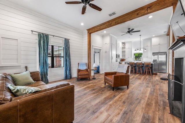 608 N Belknap, Stephenville, TX 76401 - living area featuring ceiling fan, wood finished floors, ornamental molding, wooden walls, and recessed lighting