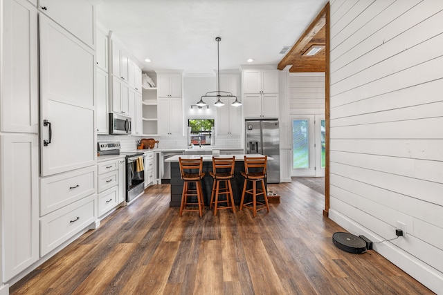 608 N Belknap, Stephenville, TX 76401 - kitchen featuring stainless steel appliances, open shelves, decorative backsplash, white cabinets, and a kitchen island