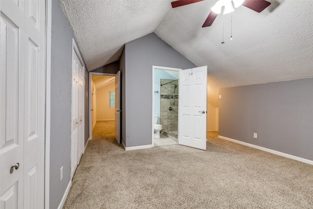410 Lone Oak Cir, Euless, TX 76039 - unfurnished bedroom with a textured ceiling, carpet, lofted ceiling, ensuite bath, and a ceiling fan