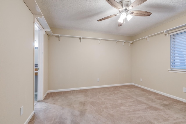 410 Lone Oak Cir, Euless, TX 76039 - spare room with light colored carpet, a ceiling fan, a textured ceiling, and baseboards