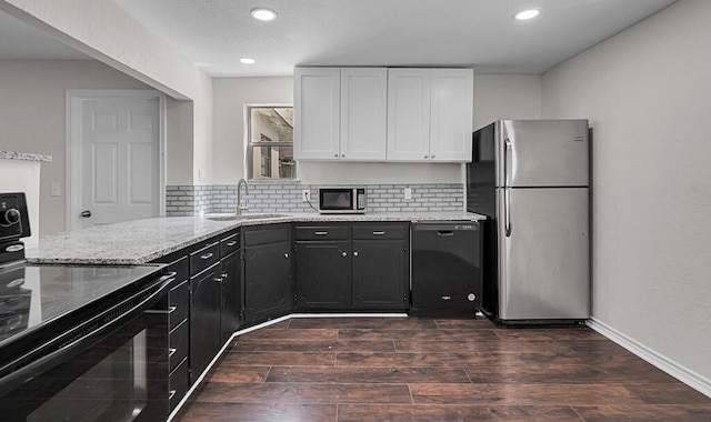 2709 Sarah St, Waco, TX 76706 - kitchen featuring black appliances, a sink, light stone countertops, white cabinetry, and recessed lighting
