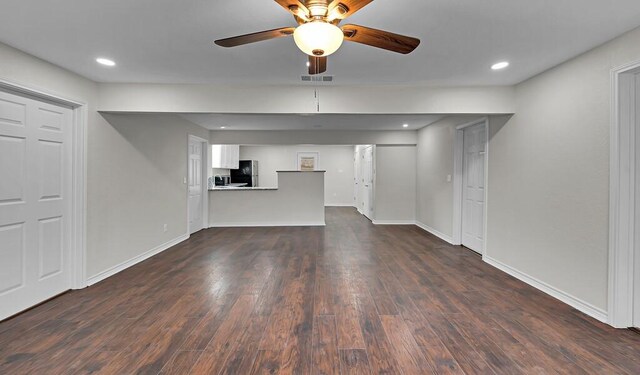 2709 Sarah St, Waco, TX 76706 - unfurnished living room featuring ceiling fan, dark wood-style flooring, baseboards, and recessed lighting