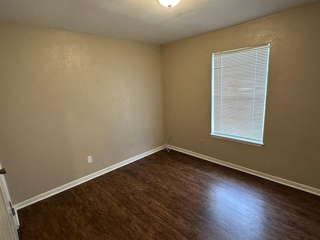 204 Austin Ave, Corsicana, TX 75110 - empty room with dark wood finished floors and baseboards