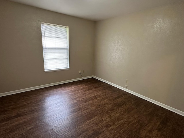 204 Austin Ave, Corsicana, TX 75110 - unfurnished room featuring dark wood-type flooring and baseboards