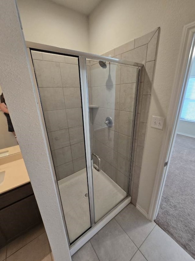 556 Pleasant Park Dr, Wilmer, TX 75172 - full bath with a stall shower, tile patterned flooring, vanity, and baseboards