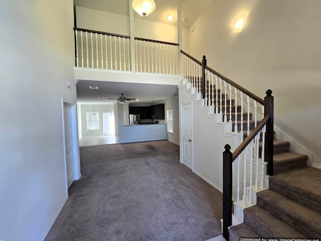556 Pleasant Park Dr, Wilmer, TX 75172 - staircase with a towering ceiling, carpet flooring, baseboards, and a ceiling fan