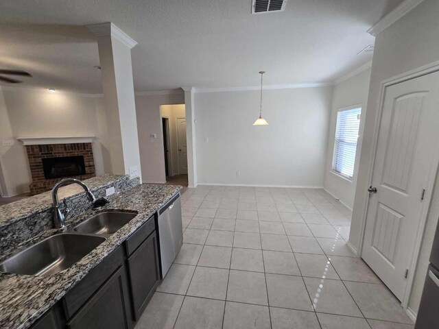 556 Pleasant Park Dr, Wilmer, TX 75172 - kitchen featuring stainless steel dishwasher, crown molding, a sink, stone counters, and light tile patterned flooring