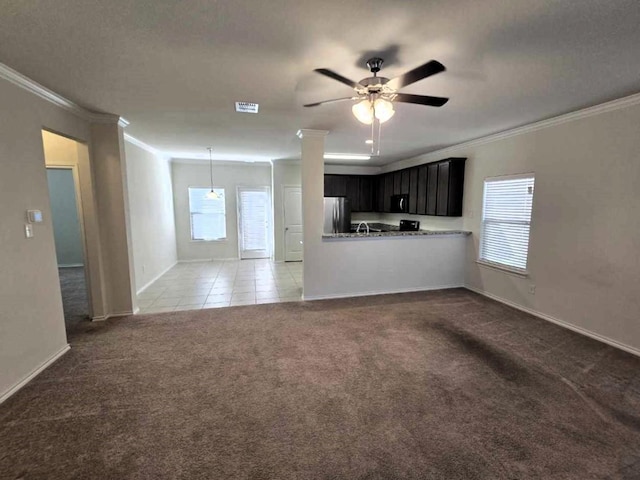 556 Pleasant Park Dr, Wilmer, TX 75172 - unfurnished living room with ornamental molding, carpet floors, baseboards, ceiling fan, and tile patterned flooring