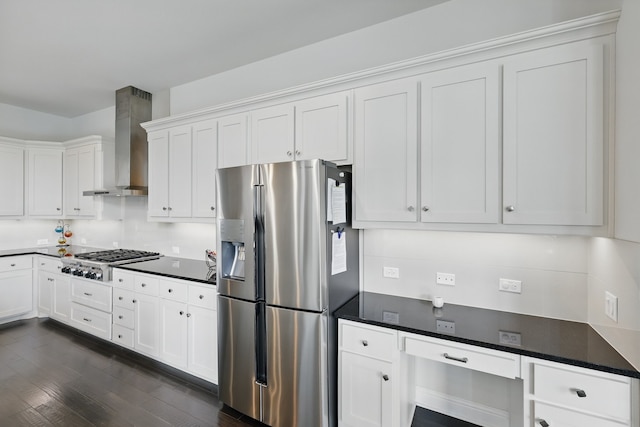 kitchen featuring stainless steel appliances, wall chimney range hood, dark wood-style floors, and white cabinetry