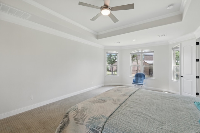 carpeted bedroom featuring a raised ceiling, baseboards, ornamental molding, and ceiling fan