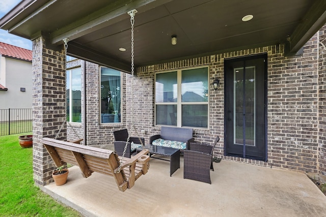 view of patio / terrace featuring outdoor lounge area and fence