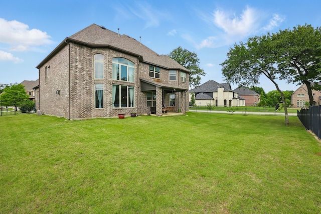 rear view of property with brick siding