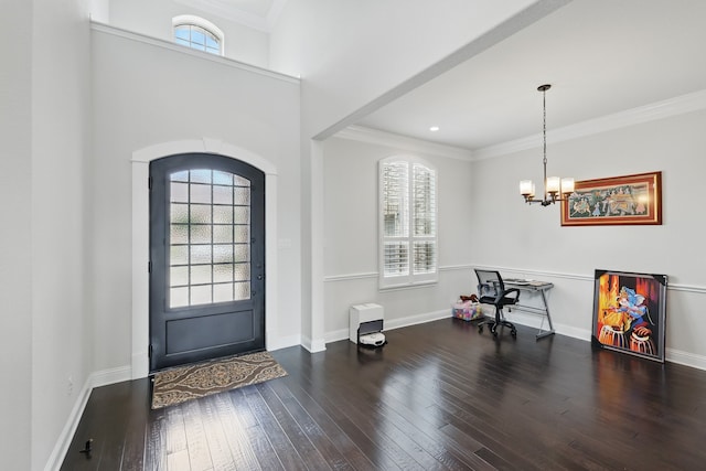 entryway featuring hardwood / wood-style flooring, arched walkways, a chandelier, baseboards, and crown molding