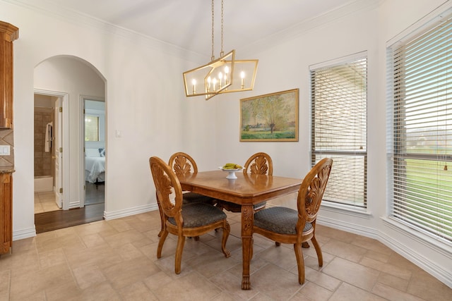11109 Brook Green Ln, Haslet, TX 76052 - dining space featuring arched walkways, crown molding, a chandelier, and baseboards