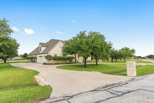 11109 Brook Green Ln, Haslet, TX 76052 - view of front of house with curved driveway, a front lawn, and an attached garage