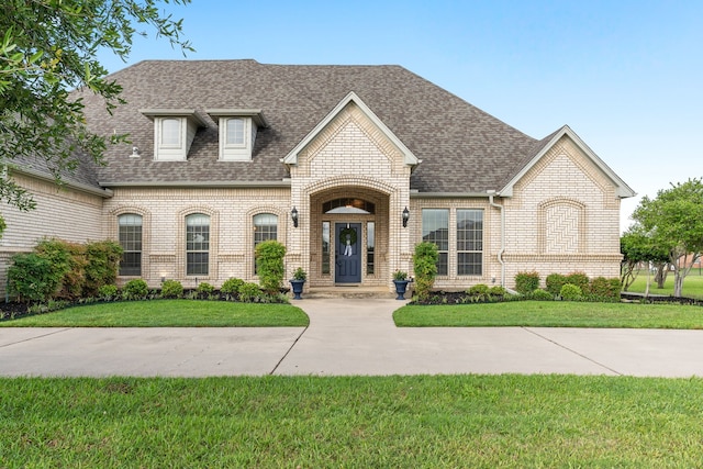 11109 Brook Green Ln, Haslet, TX 76052 - french country style house featuring brick siding, a shingled roof, and a front lawn
