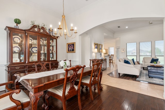 11109 Brook Green Ln, Haslet, TX 76052 - dining room featuring arched walkways, ornamental molding, a chandelier, and hardwood / wood-style floors