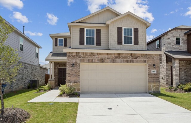 2410 Carlow Ln, Lowry Crossing, TX 75407 - view of front of home featuring an attached garage, concrete driveway, board and batten siding, and stone siding