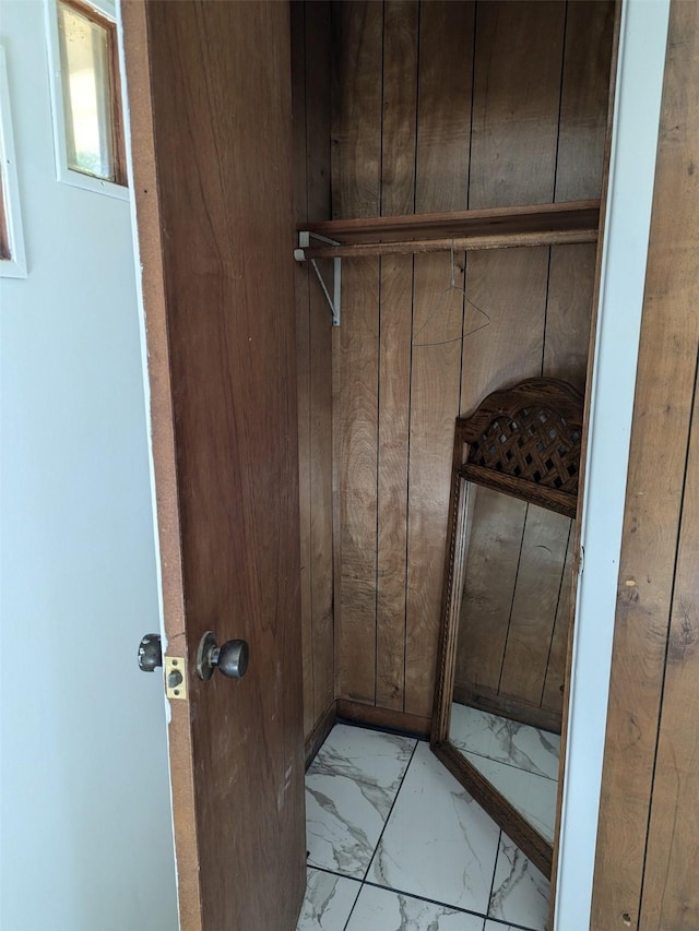 11728 Fm 1399, Marietta, TX 75566 - laundry room with marble look tiles and wooden walls
