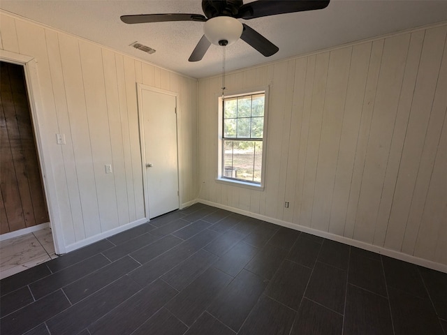 11728 Fm 1399, Marietta, TX 75566 - unfurnished bedroom with a ceiling fan, wood walls, and baseboards