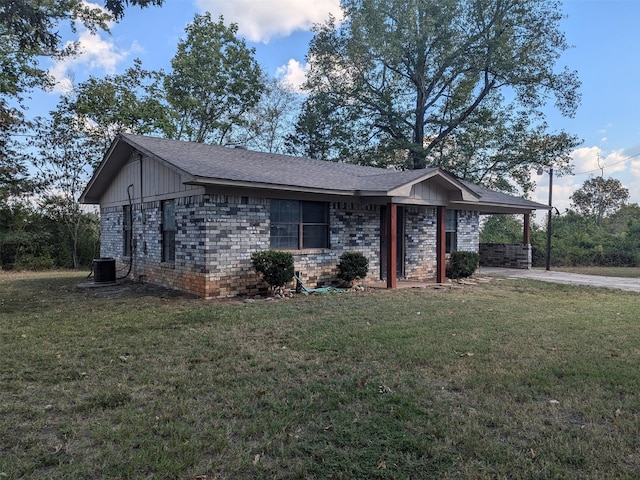 11728 Fm 1399, Marietta, TX 75566 - view of front of property featuring a front lawn, concrete driveway, central air condition unit, and brick siding