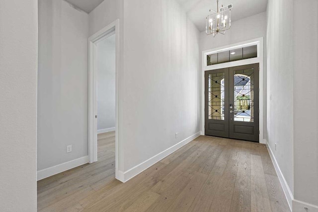 4316 Sandbrock Pkwy, Aubrey, TX 76227 - foyer entrance featuring french doors, wood-type flooring, and a chandelier
