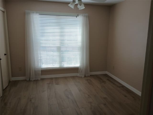 539 W Lookout Dr Unit 135, Richardson, TX 75080 - empty room featuring light wood finished floors, ceiling fan, and baseboards