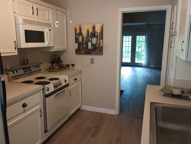 539 W Lookout Dr Unit 135, Richardson, TX 75080 - kitchen featuring white appliances, baseboards, french doors, light countertops, and white cabinetry