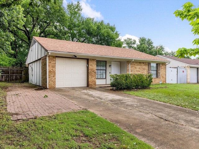 4704 Kristie Dr, Balch Springs, TX 75180 - view of front facade with brick siding, an attached garage, board and batten siding, concrete driveway, and a shingled roof