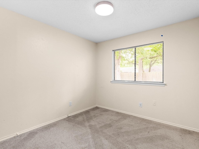 4704 Kristie Dr, Balch Springs, TX 75180 - empty room with carpet floors, baseboards, and a textured ceiling