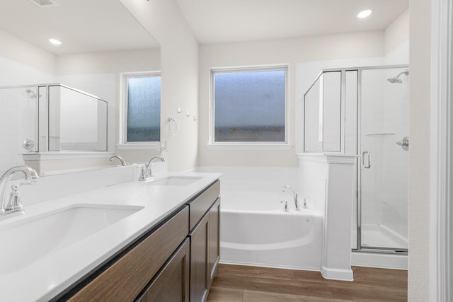 628 Hidden Cove Dr, Princeton, TX 75407 - full bath featuring wood finished floors, a shower stall, a bath, and double vanity