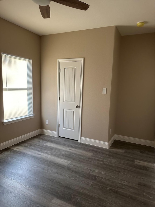 1009 S Preston St, Ennis, TX 75119 - spare room with ceiling fan, dark wood-style floors, baseboards, and a smoke detector