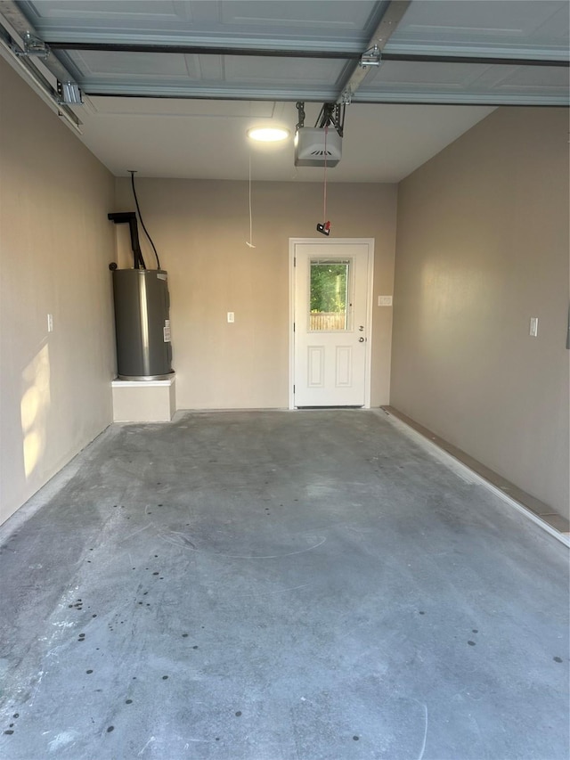 1009 S Preston St, Ennis, TX 75119 - garage with electric water heater and a garage door opener