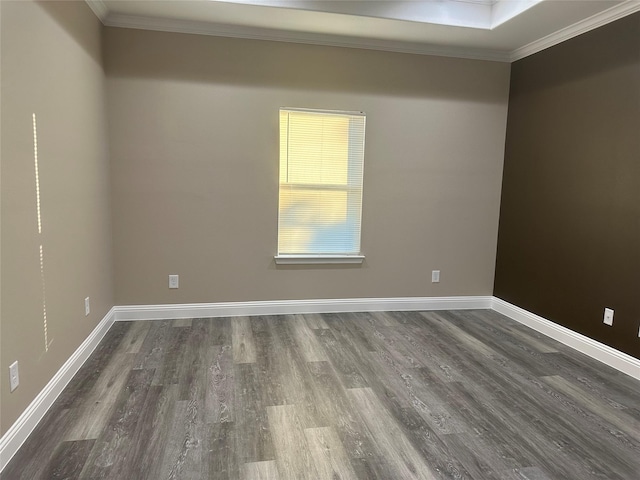 1009 S Preston St, Ennis, TX 75119 - spare room featuring ornamental molding, dark wood-style flooring, and baseboards