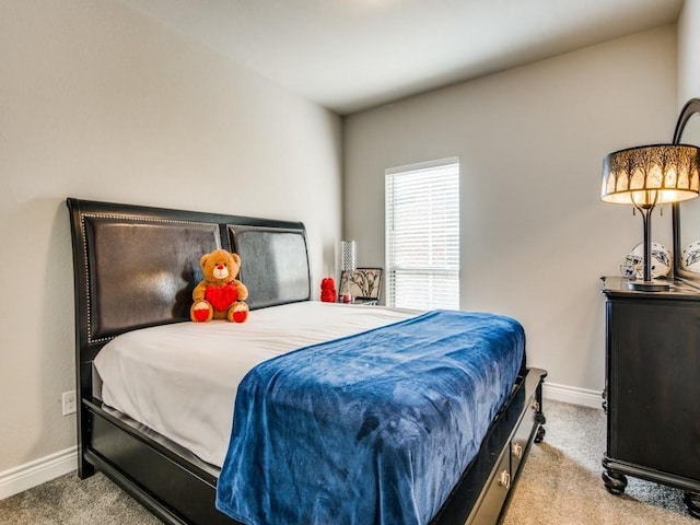 carpeted bedroom featuring baseboards