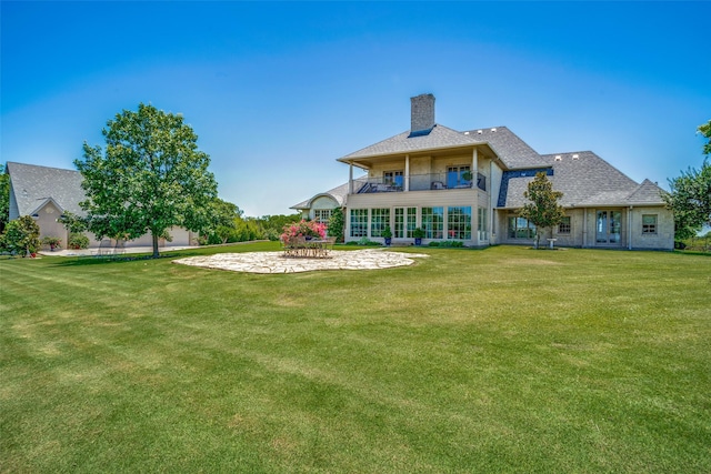 950 Sugar Ridge Rd, Ennis, TX 75119 - rear view of property with a balcony, a chimney, a patio, and a yard