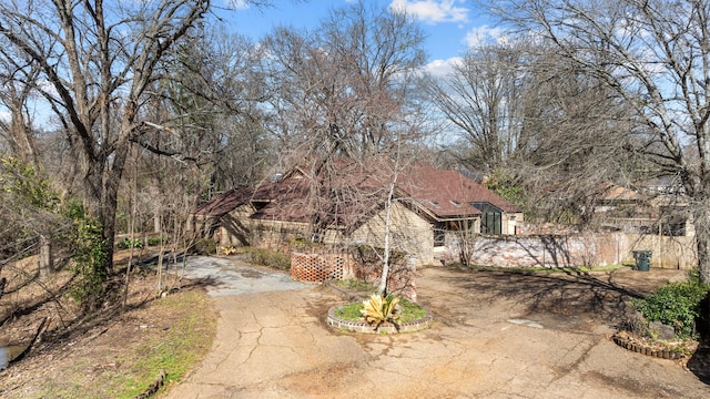 view of yard with fence and driveway