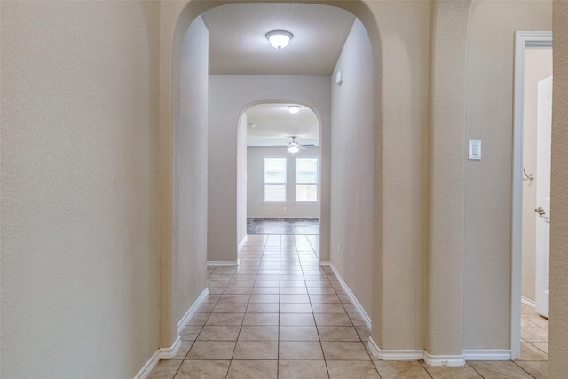 1004 Pierz Dr, Fort Worth, TX 76177 - hall featuring arched walkways, light tile patterned flooring, and baseboards