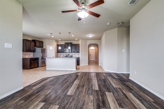 1004 Pierz Dr, Fort Worth, TX 76177 - unfurnished living room with arched walkways, a ceiling fan, light wood finished floors, and recessed lighting