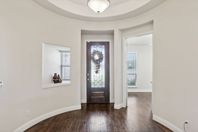foyer featuring wood finished floors and baseboards